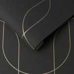 Black wallpaper with fine metallic gold curves forming a subtle geometric pattern on textured surface