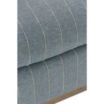 Tight detail showing overlapping upholstery layers on armrest and seat cushion corner