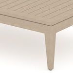 Close-up of corner showing slatted teak surface texture and tapered leg detail.