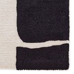 Close-up showing detailed tufting and transition between black and cream sections