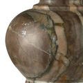 Close-up of pistachio green marble base showing natural veining and smooth polish.