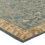 Close-up of rug corner showing hand-sheared wool texture and gold bordered edge
