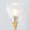 Close-up of faceted K9 crystal shade and brass socket showing texture and transparency details