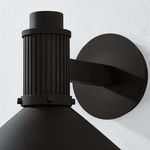 Close-up of textured black ribbed cap and circular backplate of Elani Exterior Wall Sconce