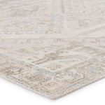 Close-up angled view showing low cut-loop pile texture and detail of light brown and pink geometric pattern