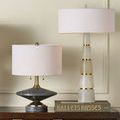 Jebel Table Lamp on wooden cabinet beside taller alabaster table lamp with brass accents