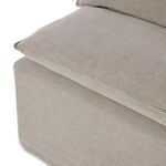 Side angle emphasizing relaxed linen fabric, piping details, and slipcover drape