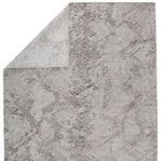 Rug folded at one corner exposing the lighter, less textured backing
