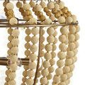 Close-up of beige silken fabric beads alternating with textured golden nugget beads on wrought iron frame