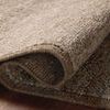 Rolled edge detail highlighting thickness and wool material on a wooden floor