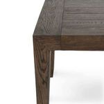 Close-up of corner showing wood grain texture and joinery details on the tapered leg and tabletop edge