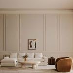 Thomas sectional in a spacious living room with paneled walls, wall art, and a brown upholstered chair