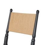 Close-up detail of paper cord backrest between rounded black ash vertical posts