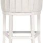 Rear view of Ryder stool revealing vertical channel tufting on the backrest and tapered wood legs