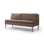Three-quarter side view showing the one armrest on the right side and tapered wooden legs
