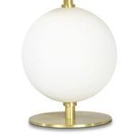 Close-up of white spherical metal base and round brass finished stand of lamp