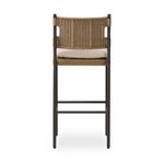 Rear view revealing woven wicker back and beige cushion from behind