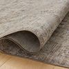 Rolled section of Ida Slate Natural rug with visible texture and muted, earthy color variation