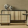 Styled room with two raffia credenzas and black and white ceramic vases on one credenza