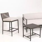 Pietra Counterstool styled indoors beside matching coffee table and sofa in a white room