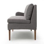 Side profile highlighting thick seat cushion, back cushions, and amber oak legs of banquette