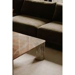 Close-up of Bryn sectional seat cushions next to marble coffee table with warm natural lighting