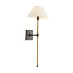 Side angle view of sconce turned on, white linen shade illuminated softly