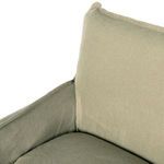 Tight angle showing joined khaki linen slipcover on armrest and back cushion