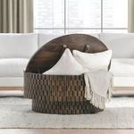 Norwood coffee table with open top storing light-colored pillows and throw inside