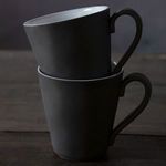 Two white Lagoa Eco Gres mugs stacked, showing side view of handles and matte finish