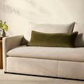 Side view of Liza pillow styled on beige sofa in neutral living room setting