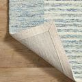 Kerfed corner turned up to display the underside cotton or jute backing of the rug