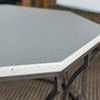 Macro detail of textured sandstone white faux stone surface on table corner