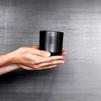 Ceto Cup held in hand showing scale and slight sheen difference on textured black ceramic surface