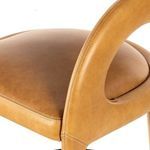 Close-up detail of seat and armrest stitching on butterscotch leather stool