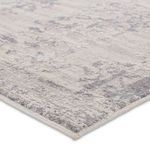 Close-up of rug edge showing thin border and textured, distressed vintage look