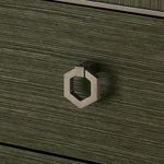 Hexagonal satin bronze drawer pull on olive grasscloth textured drawer front