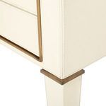 Detail of corner stitching and brass trim on the table leg