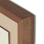 Detail of the walnut wood frame corner, highlighting the smooth finish and grain
