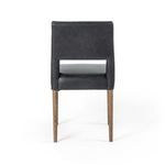 Lower seat area focusing on leather upholstery lapped neatly over edges and tapered legs