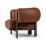 Focus on thick leather backrest curvature with stitching details