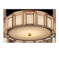 Flush mount ceiling light shown from low angle with illuminated white diffuser and brass frame
