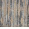 Close-up of Beckett rug surface revealing textured fibers and detailed geometric pattern in tan and gray