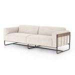 Angled view re-showing wood paneling and leather straps at sofa's rear side
