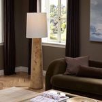 Daxton Floor Lamp styled in living room corner next to olive green sofa and window with natural light
