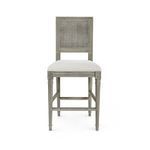 Front view of Annette Counter Stool shows symmetrical cane backrest and carved rosette details on legs