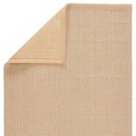 Rug flipped corner showing solid beige woven backing contrasting the trellis top