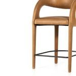 Lower frame view focused on legs, leather upholstery and black metal footrest