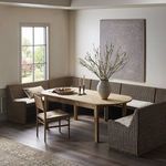 Wide angle of styled dining room featuring banquette, wooden dining chair, and large window