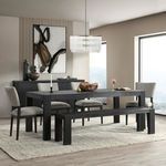 Black dining table styled with bench and upholstered chairs in a neutral modern dining room